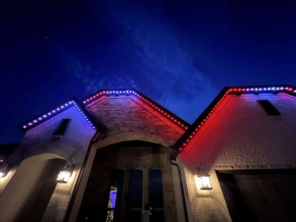 Roofline glowing with red, white, and blue permanent LED lighting at night